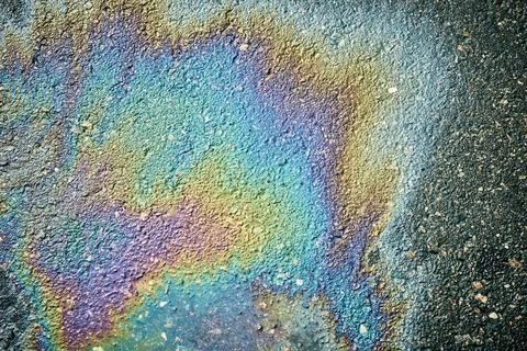 Oil Slick Forms Colorful Patterns on Asphalt Surface After Rain in an Urban Stock Photos