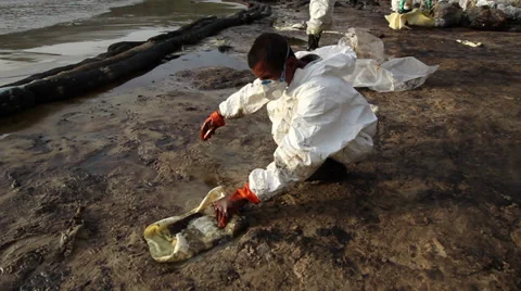 OIL SPILL DISASTER WORKERS CLEAN TROPICAL BEACH Stock Footage 27576236