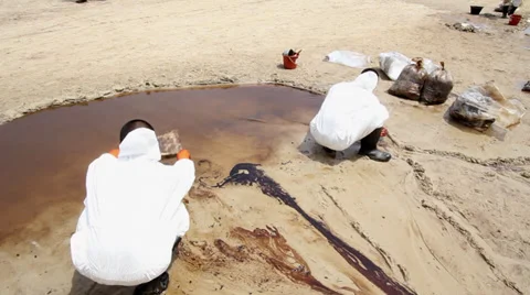 OIL SPILL DISASTER WORKERS CLEAN TROPICAL BEACH Stock Footage 27625521