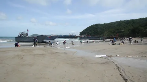 OIL SPILL DISASTER WORKERS CLEAN TROPICAL BEACH Stock Footage 27645372