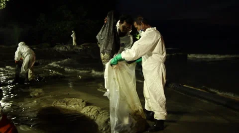OIL SPILL DISASTER WORKERS NIGHTTIME CLEAN UP Stock Footage 27837782