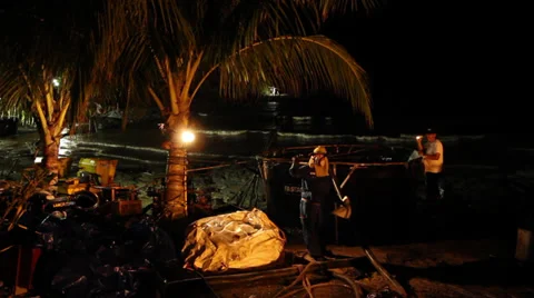 OIL SPILL DISASTER WORKERS NIGHTTIME CLEAN UP Stock Footage 27845223