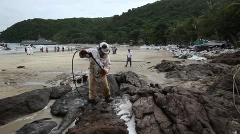 OIL SPILL DISASTER WORKERS SPRAY CHEMICAL DISPERSANTS CLEAN UP Stock Footage 27890080