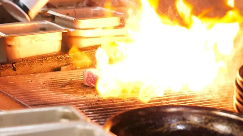 Oil sprayed on meat while grilling Stock-Footage 127930108