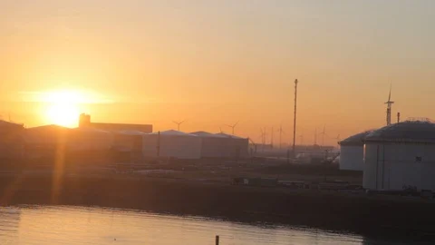 Oil storage and background with windfarms , sunrise in europeian port Stock Footage 130161642