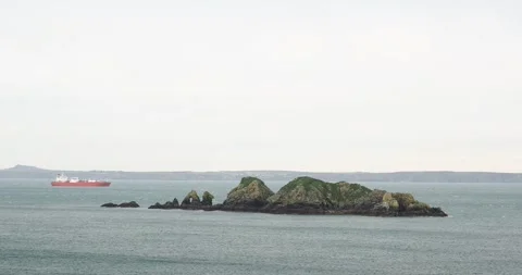 An oil tanker anchored off Stack Rocks in St Brides Bay, Pembrokeshire, Wales 스톡 동영상 256111419
