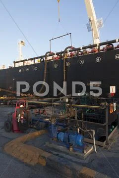 Oil Tanker Ship Docked In Industrial Harbor