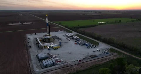 Oil Well Drill Rig Fields and Sunset Drone Aerial View Burleson County Texas USA Video stock 335669326