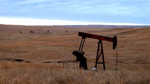 Oil Well Pump Jack pumping crude oil for fossil fuel energy in America Stock Footage 128927965