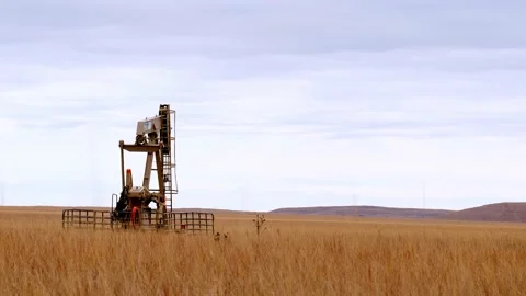 Oil Well Pump Jack pumping crude oil for fossil fuel energy. Stock Footage 142958317