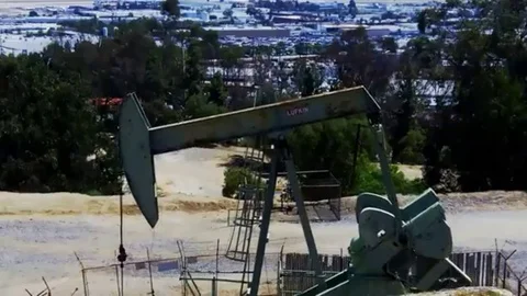 Oil well pumping rig in the foregroundbackground Stock Footage 98578907