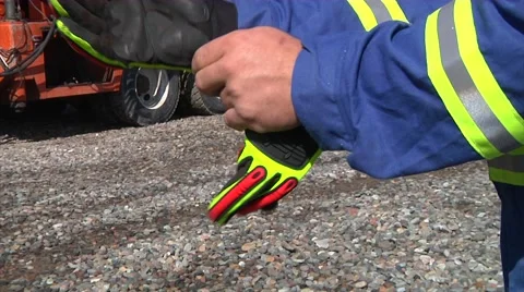 Oil worker puts on gloves 2 Stockbeeldmateriaal 40367335