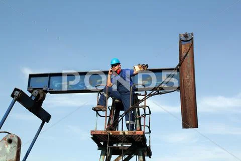 Oil worker talking on mobile phone Stock Photos