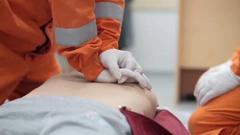 Oil workers practicing CPR chest compressions Stock Footage 321314291