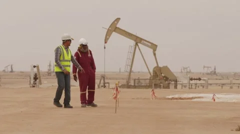 Oil Workers At Well Pump Jack Site Video stock 62087777