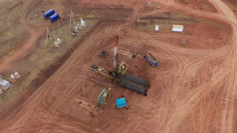 Oil workers work with an oil rig in an oil field. Aero Video stock 168506250