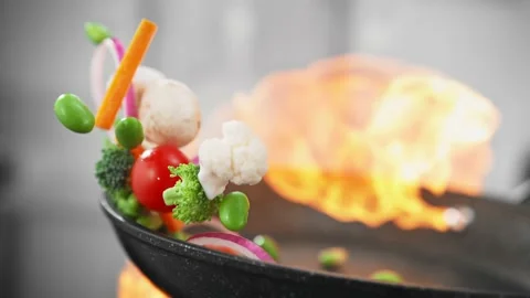 Oiled frying pan sprinkle with stir-mushrooms and vegetables. 4K Footage Stock Footage 232986011