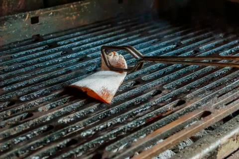 Oiling bbq mesh with bacon Stock Photos