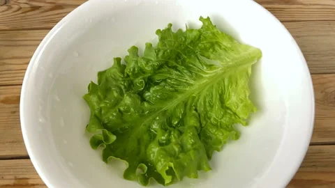 Oils Falling down in plate slowly, cooking fresh salas with vegetables, top v Stock Footage 132311153