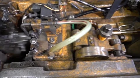 Oily cold heading machine runs at speed inside a screw factory with brass Vídeo Stock 346737882