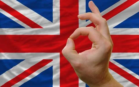 Ok gesture in front of uk national flag Stock Photos