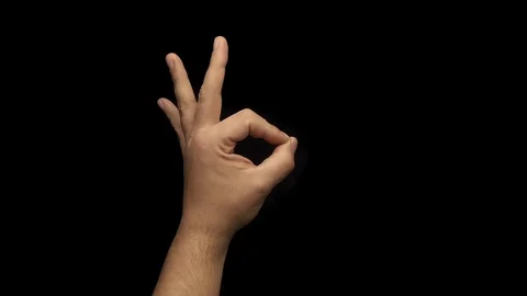 Ok hand gesture slow motion black background Stock Footage 124087415