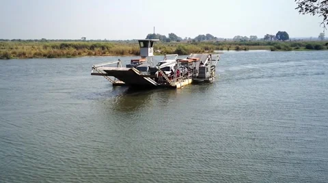 Okavango River ferry transporting people &amp; vehicles for free (Africa). Stock Footage 44102788