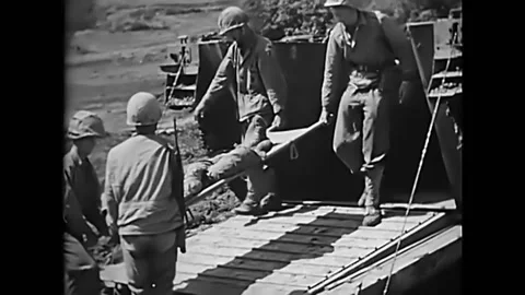 OKINAWA - 1945 - Medics load wounded soldiers on stretchers onto a truck in Video stock 287744178