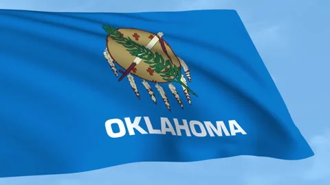 Oklahoma flag waving on a clear blue sky Stock Footage 323637343