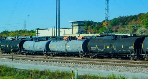 Oklahoma: A long freight train consisting of numerous black and gray tank c.. Stock Photos