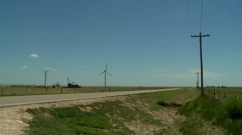 Oklahoma Panhandle power windmills and old house Stock Footage 40447697