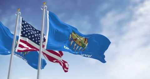 The Oklahoma state flag waving along with the national flag of the United S.. Stock Footage 321360147