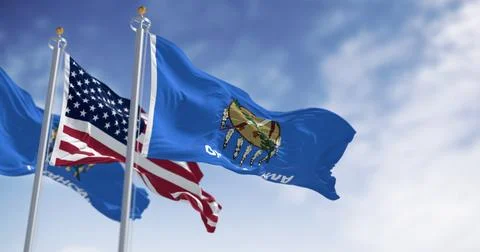 The Oklahoma state flag waving along with the national flag of the United S.. Stock Illustration