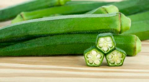 Okra on a wooden background Stock Photos