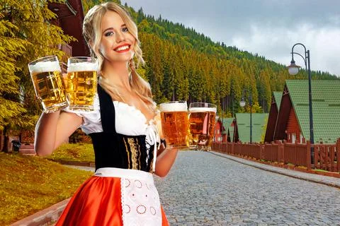 Oktoberfest girl waitress with beer, wearing a traditional Bavarian or german Stock Photos