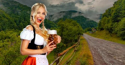 Oktoberfest girl waitress with beer. Woman wearing a traditional Bavarian or Stock Photos