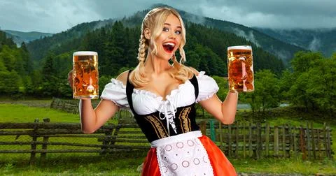 Oktoberfest girl waitress with beer. Woman wearing a traditional Bavarian or Stock Photos