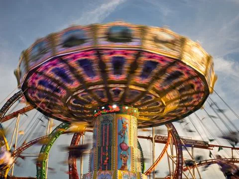 Oktoberfest Munich swing carousel in motion at sunset festival Stock Photos