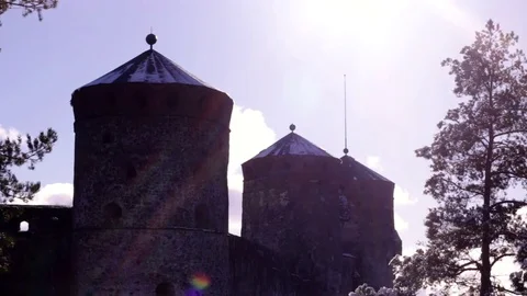 Olavinlinna castle towers behind pine trees Stock Footage 74080676