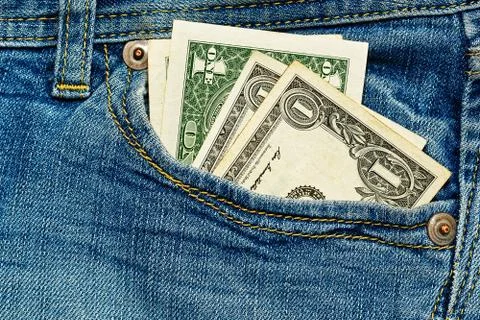 Old 1 dollar notes in jeans pockets Stock Photos