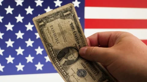 An old 1935 "One Dollar" Bill in male hand on a US Flag Background 스톡 동영상 201497947
