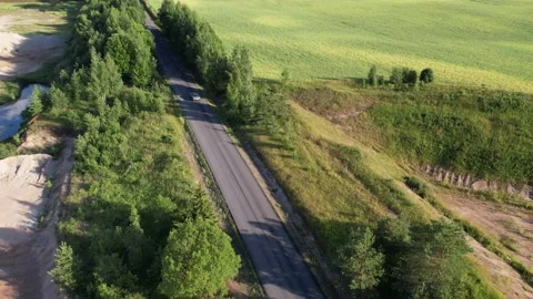 Old 70's historic and unique car driving on green landscapes and roads 스톡 동영상 230078989