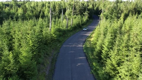 Old 70's historic and unique car driving on green landscapes and roads Stock Footage 230079117
