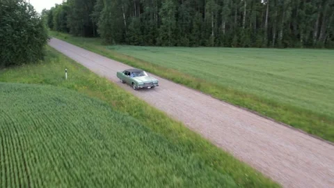 Old 70's historic and unique car driving on green landscapes and roads Video stock 230079138