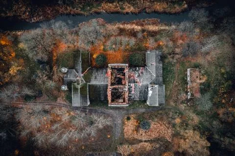 Old abandoned and spooky manor aerial view in autumn. Stock Photos