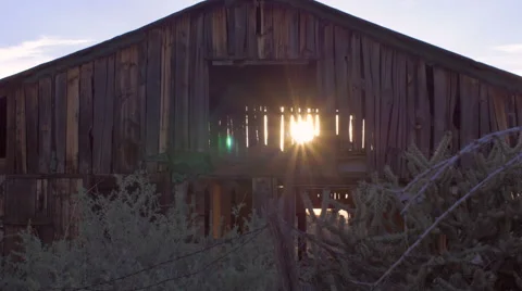 Old abandoned barn with sun light streaming through open beams Stockbeeldmateriaal 49213001