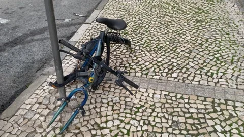 Old abandoned broken bicycle frame locked to a pole. Stock Footage 300886384