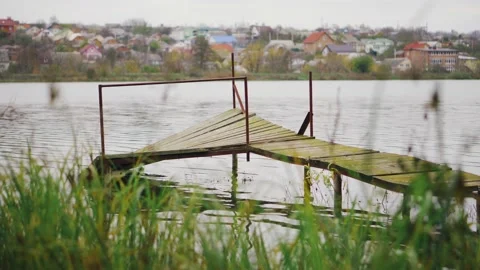 Old abandoned broken pier on the river bank in autumn weather Stock Footage 143242280