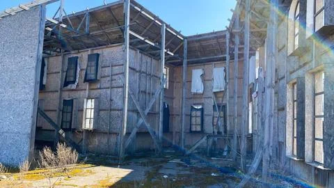 Old abandoned building with broken windows and wooden beams Stock Photos