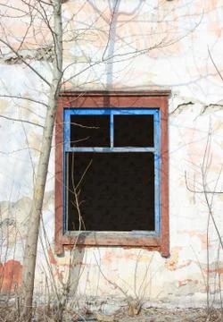 Old abandoned building - empty windows with broken glasses. Stock Photos